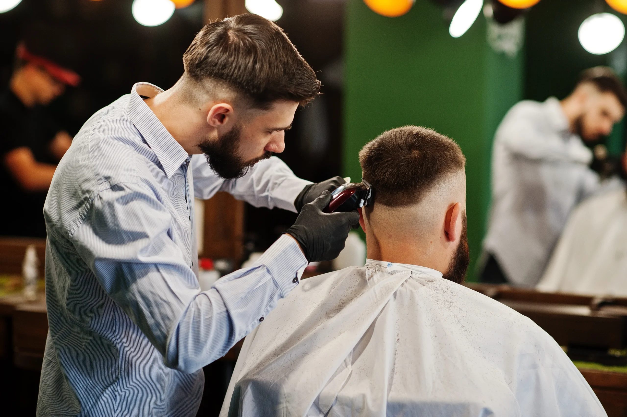 Barber providing men's haircut services to a client.