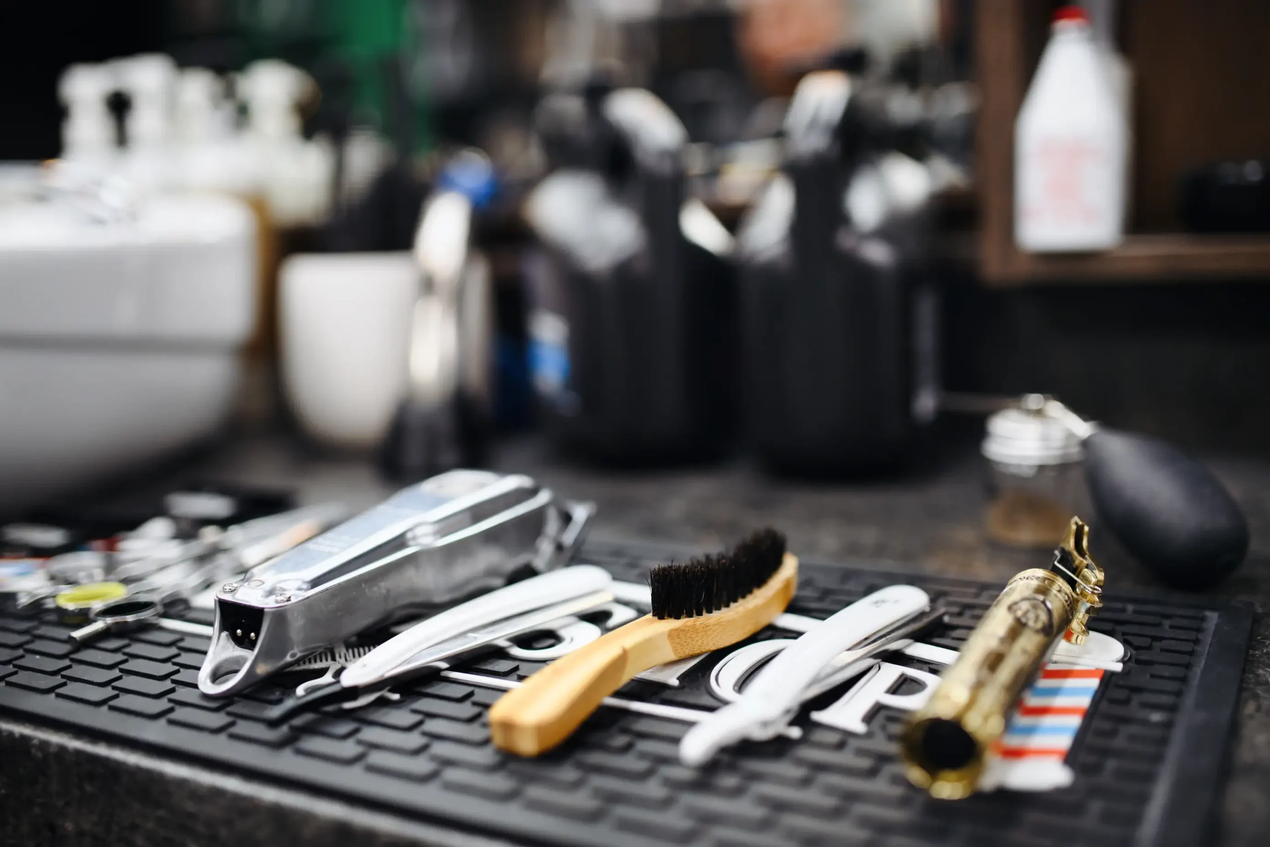Close-up of grooming tools neatly arranged at a barbershop station.